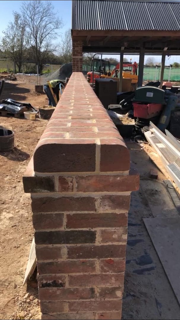 Wall with rounded brick on edge
